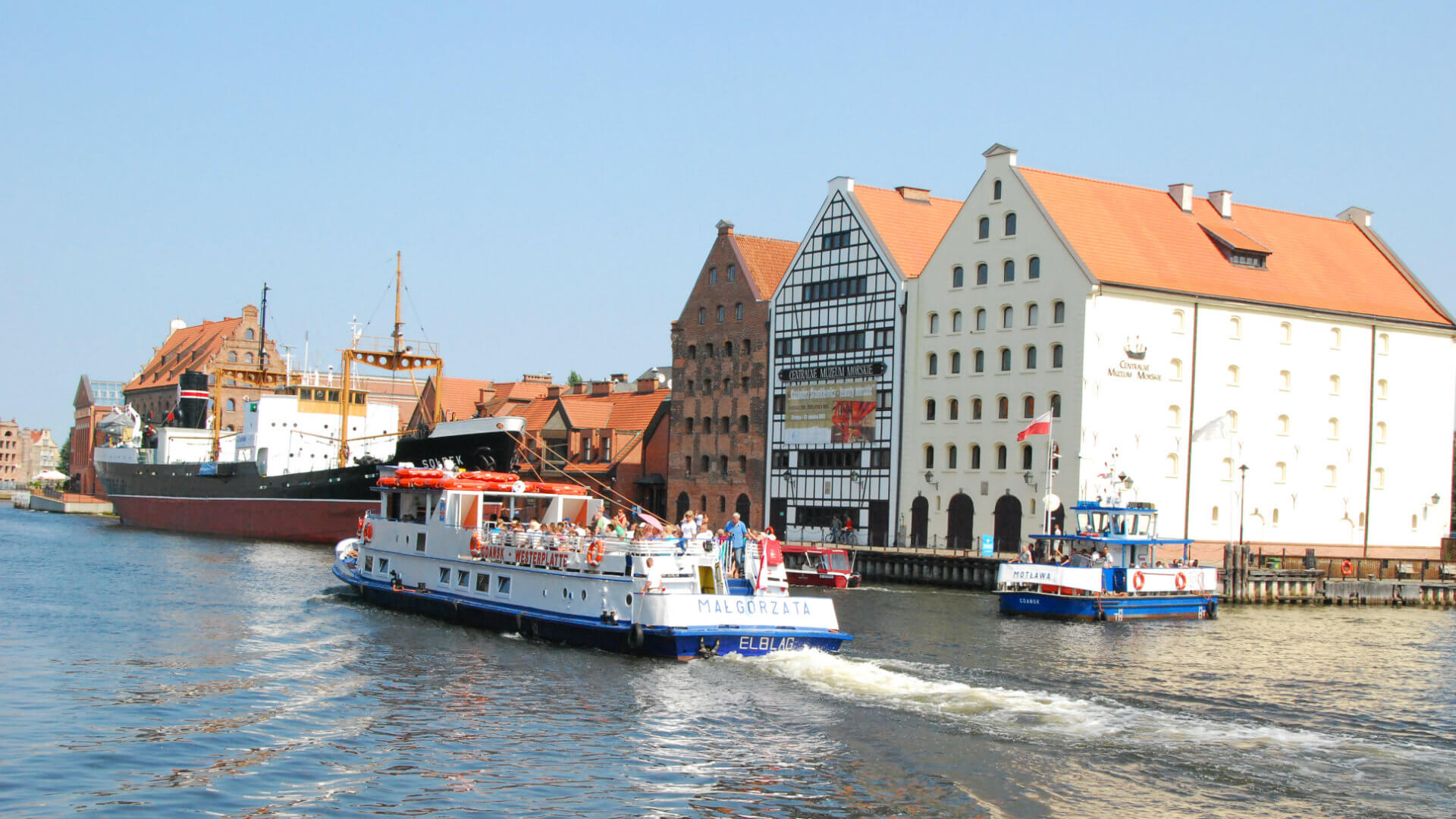 View at the Motława river. Ferries take tourists for boattrips. The buildings were also old granaries.